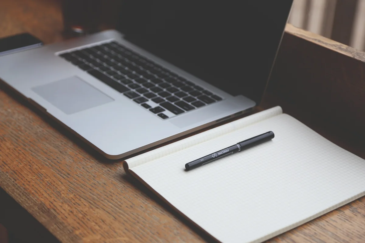 Laptop and notebook representing the CaribResorts Terms of Use