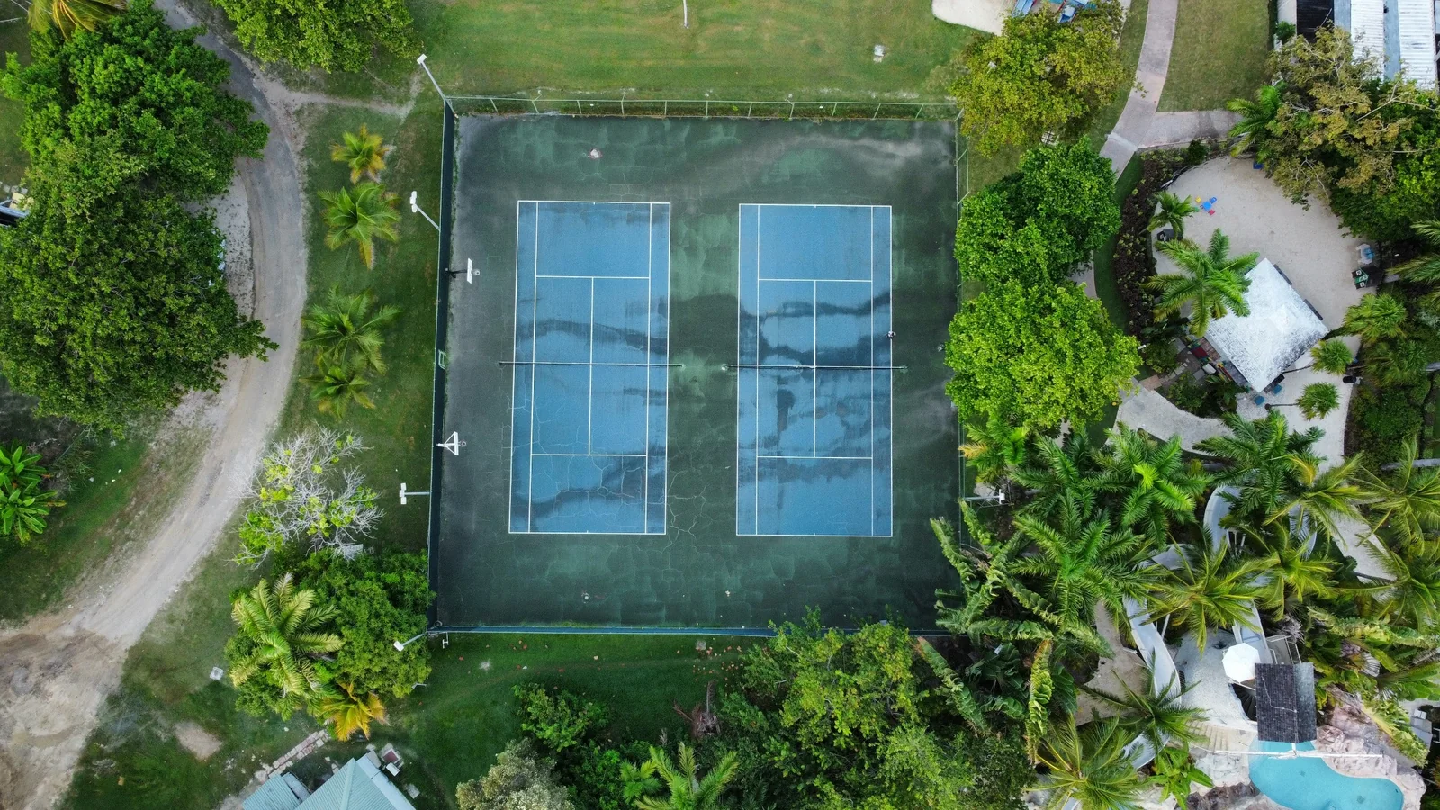Tennis courts surrounded by tropical vegetation at a Montego Bay resort